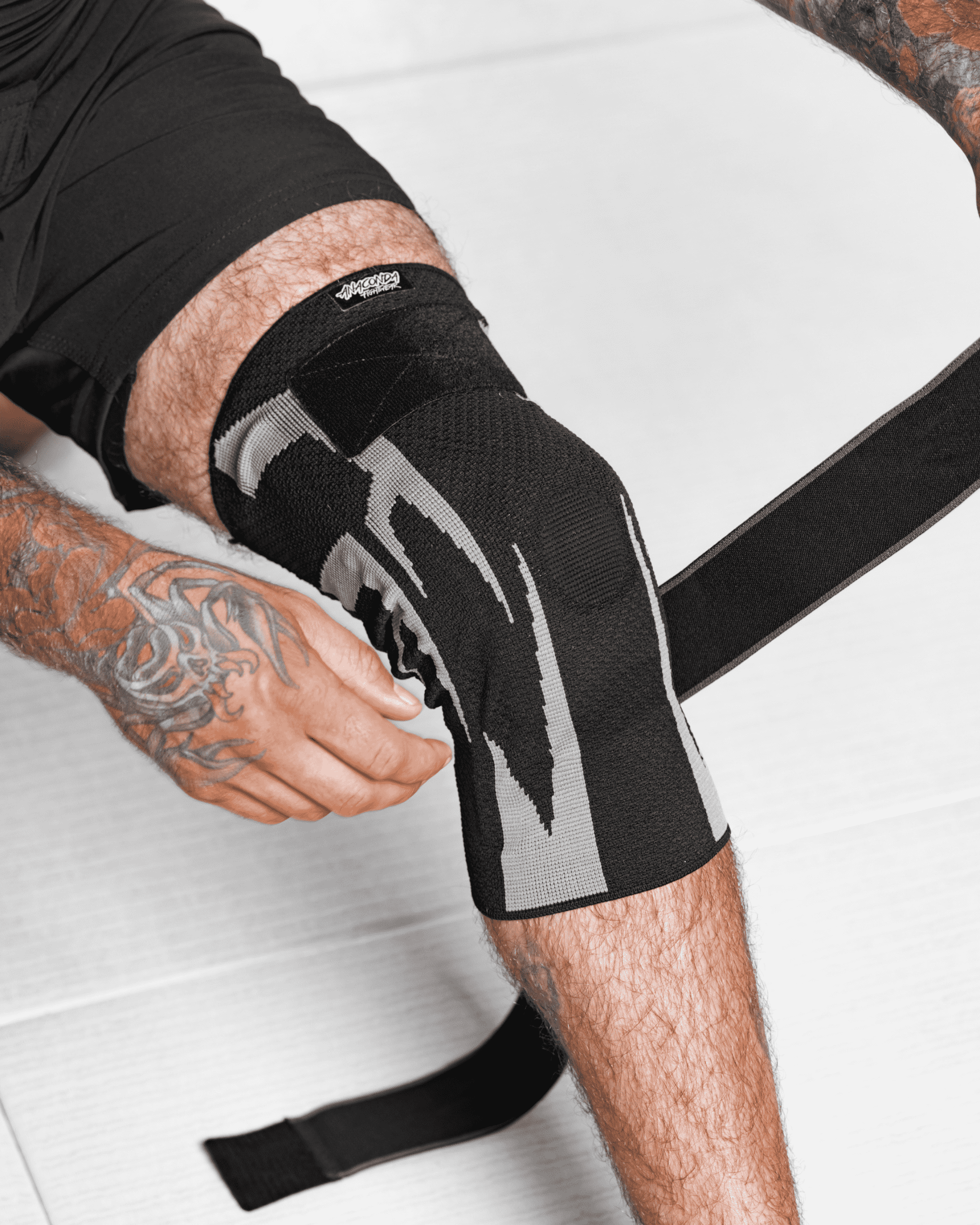 A man kneeling in athletic gear with a focused expression.